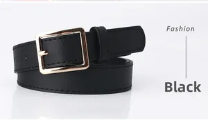 Detail of slim black leather belt featuring a polished gold square pin buckle for women