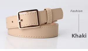 Detailed close-up of khaki fashion belt featuring a square gold metal buckle and smooth PU leather
