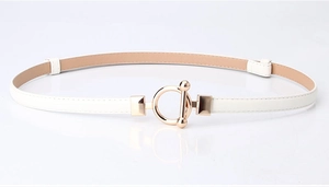 Close-up of white skinny belt with light gold round buckle for summer dresses
