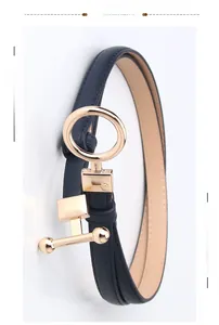 Detailed close-up of dark blue slim leather belt with a polished gold geometric metal buckle