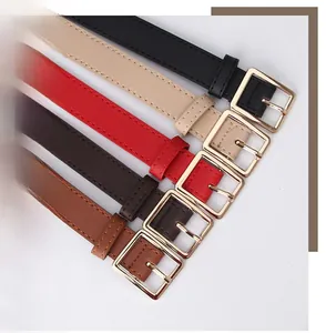 Close-up of minimalist women's belts with golden square buckles and litchi texture