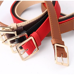 Detail of colorful thin faux leather belts for women with polished gold square buckles