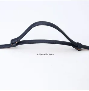 Detail showing the adjustable design of the navy blue slim faux leather strap with stitching