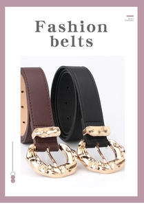 Detail view of fashion belts featuring irregular hammered gold metal buckles and stitching