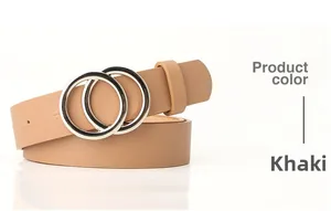 Detailed shot of khaki leather belt featuring a classic silver double ring metal buckle
