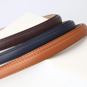 Three premium leather belts in dark coffee, navy, and caramel with fine stitching details