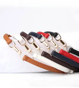 Detail view of multi-color slim leather belts with polished gold U-shape metal buckles