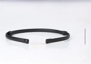 Close-up detail of a minimalist black slim belt with a modern gold D-shaped metal buckle