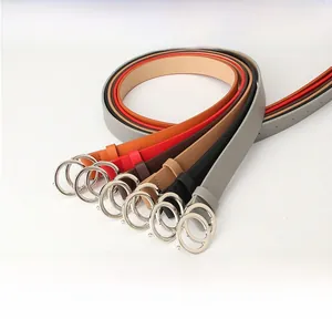 Detail of colorful women's skinny belts featuring stylish silver metal double O-ring buckles
