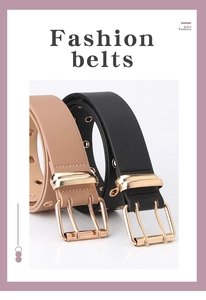 Detail view of black and camel leather belts with gold double-pin buckles and metal eyelets