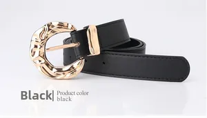 Macro shot of stylish black leather belt featuring a textured gold irregular round buckle