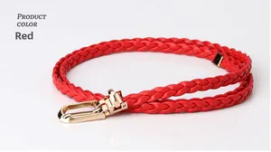 Detail of red braided leather skinny belt with polished gold metal buckle and metal tip