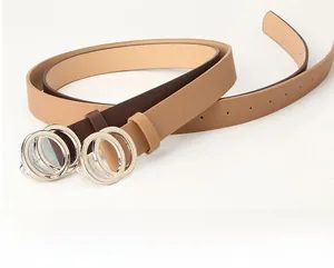 Detail view of stylish women's belts with silver double ring buckles in brown and khaki