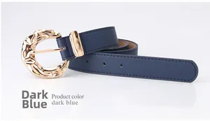 Detailed close-up of dark blue leather belt with irregular wave golden buckle texture