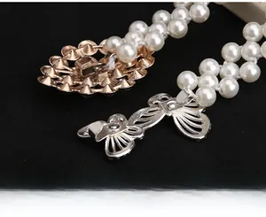 Details einer Perlen-Tailienkette mit Strass-Schnalle und Metall-Schleifenverschluss