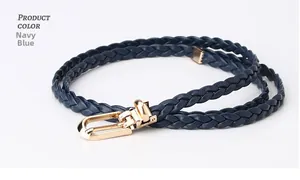 Detailed macro view of navy blue braided thin belt featuring a polished golden U-shaped buckle