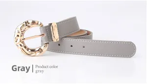 Detail of gray leather belt with white stitching and gold irregular lava metal buckle