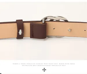 Detailed view of the silver interlocking double-ring buckle on a wide brown leather belt