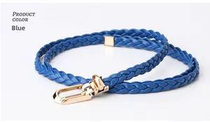 Detail of blue woven skinny belt featuring a golden U-shaped buckle on white backdrop