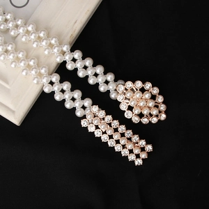 Elegante meerlaagse parelriem met gouden strass gesp op een zwarte achtergrond