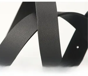 Close-up of black litchi pattern leather texture on a wide minimalist fashion waist belt