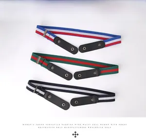 Detail of three elastic belts with striped nylon webbing and metal snap buttons