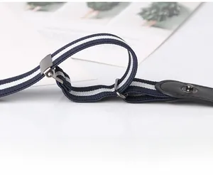 Detail of adjustable blue and white striped elastic belt with black leather snap button