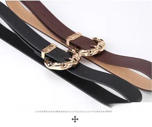 Detail of premium leather wide waist belts with gold hammered metal buckles in black and brown