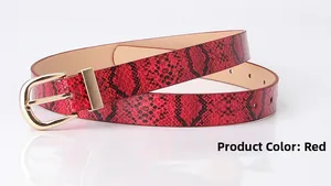 Detail of red snake pattern faux leather belt with a golden horseshoe metal buckle