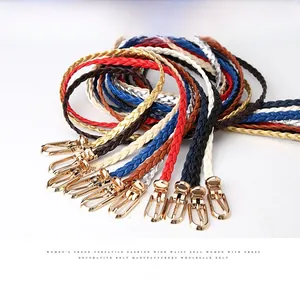 Detail view of colorful woven skinny belts with gold buckles for women dresses