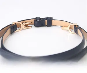 Detail of elegant navy blue skinny belt with adjustable gold alloy buckle for dresses