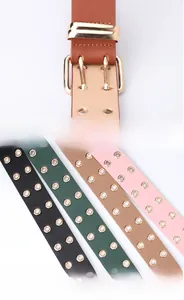 Detail of multi-color wide faux leather belts with double grommets and gold pin buckles