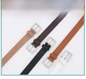 Dettaglio di sottili cinture da donna multicolori con fibbie quadrate in metallo argento