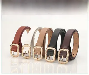 Detailed view of women's fashion belts in five colors with textured gold metal buckles