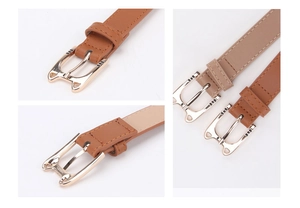Close-up of cat-shaped metal buckle on slim PU leather belts in brown and apricot