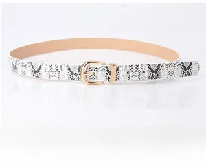 Close-up of women's snakeskin pattern belt with elegant gold-tone D-shaped metal buckle