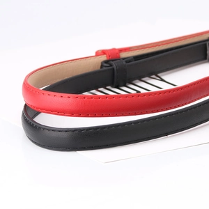 Elegant thin leather waist belt with fine stitching for women in black and red colors