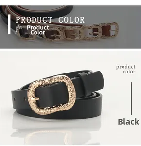 Detail of vintage embossed gold metal buckle on a black stylish leather belt for women