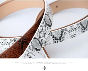 Detail shot of brown and grey snakeskin textured faux leather belts for women