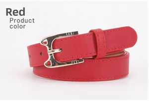Detail shot of the red faux leather belt featuring a golden cat head shaped metal buckle