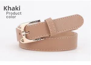 Detail of khaki leather belt showing white stitching and golden alloy buckle