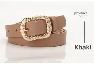 Detail of khaki leather belt showing vintage gold engraved buckle and smooth edge finish
