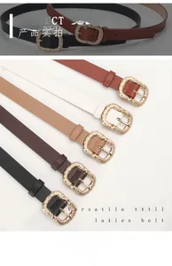 Close-up of stylish thin waist belts with vintage engraved gold buckles in multiple colors