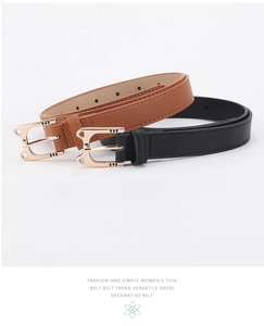 Detail of slim black and brown faux leather belts with golden alloy buckle and stitching