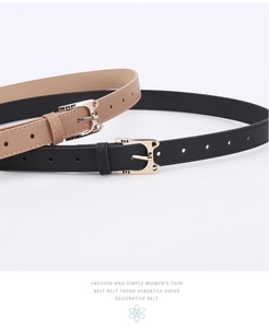 Detail view of fashion cat buckle women belts in black and beige leather with gold pins