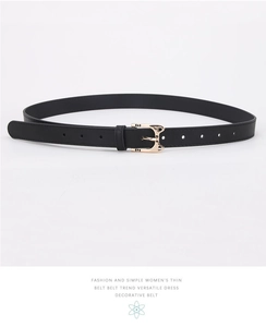 Detail of elegant black leather belt featuring a cute gold cat-shaped metal buckle