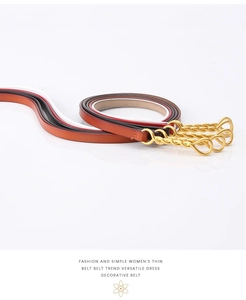 Detail view of thin leather belts for women with twisted golden hook buckles