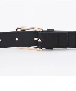 Close-up of black leather belt featuring a golden cat head metal buckle and fine stitching