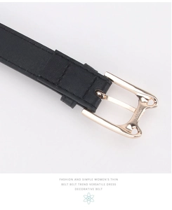 Close-up of gold cat-shaped buckle and black leather strap with stitched edges