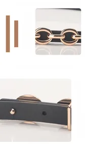 Détail d'une ceinture en cuir noir avec boucle en alliage doré et perforations latérales